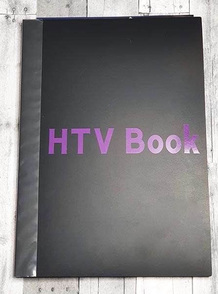 Art portfolio with the words HTV book in purple on front