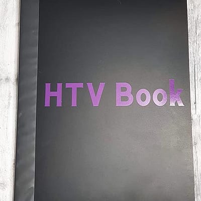 Art portfolio with the words HTV book in purple on front